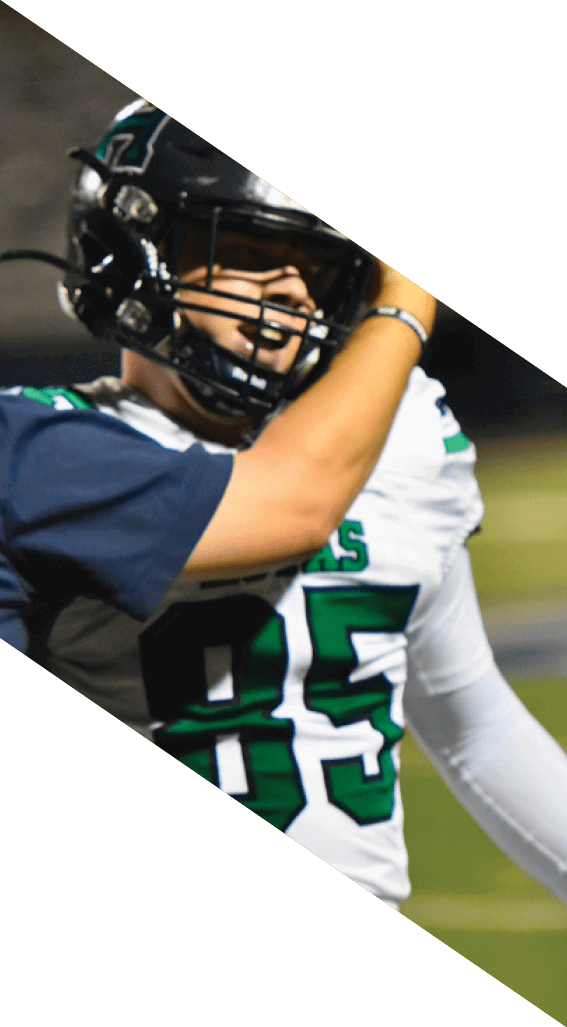 A football player wearing a black helmet and white jersey is holding a football in his hands. AI generated content