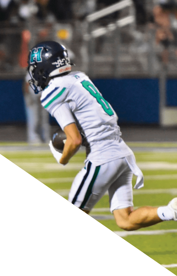A football player is kneeling on the field, holding his helmet in his hands. AI generated content