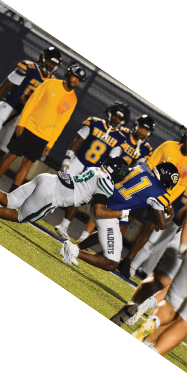 Two football players are on the field, one jumping in the air while the other is running. A referee is also present, watching the play. AI generated content