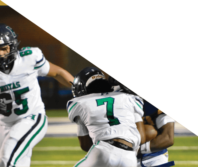 A group of football players kneeling on the field, some with their hands on their heads. AI generated content