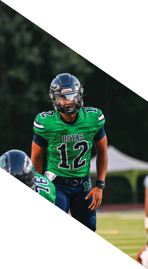 A football player wearing a black helmet and white jersey is holding a football in his hands. AI generated content