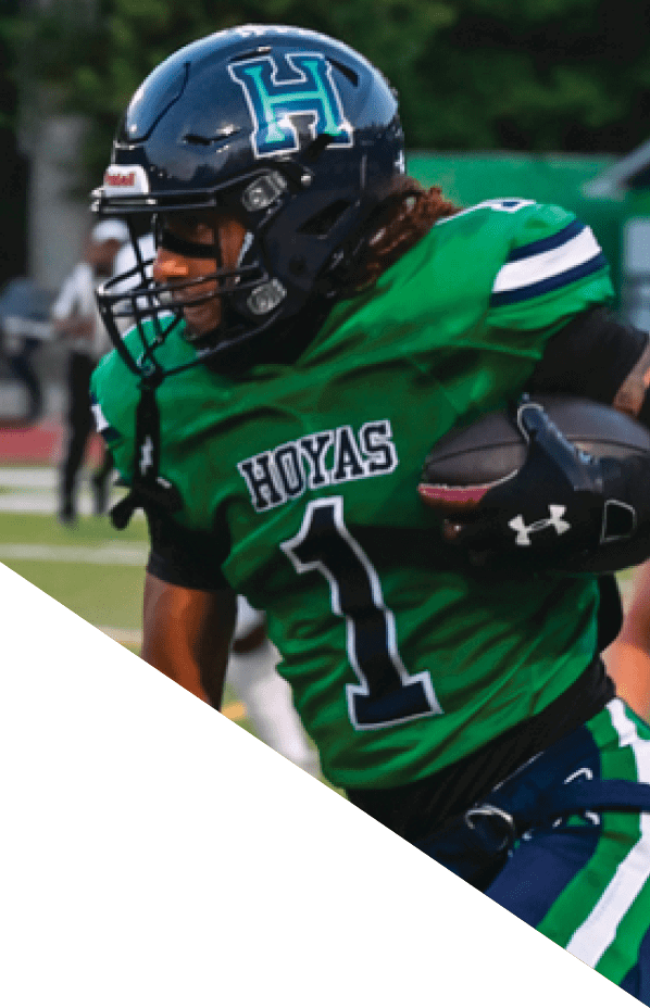 A football player is kneeling on the field, holding his helmet in his hands. AI generated content