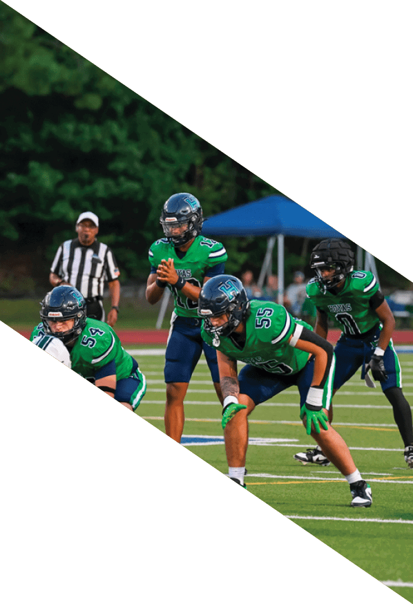 A group of young men wearing black and white uniforms are standing on a field. AI generated content