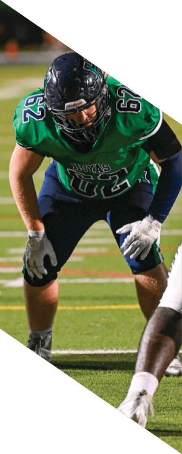 A football player wearing a helmet and white uniform is holding his helmet above his head. AI generated content