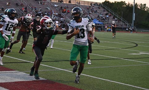 Two men wearing football uniforms are hugging each other on a field. AI generated content