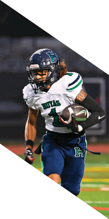 Two football players are on the field, one jumping in the air while the other is running. A referee is also present, watching the play. AI generated content
