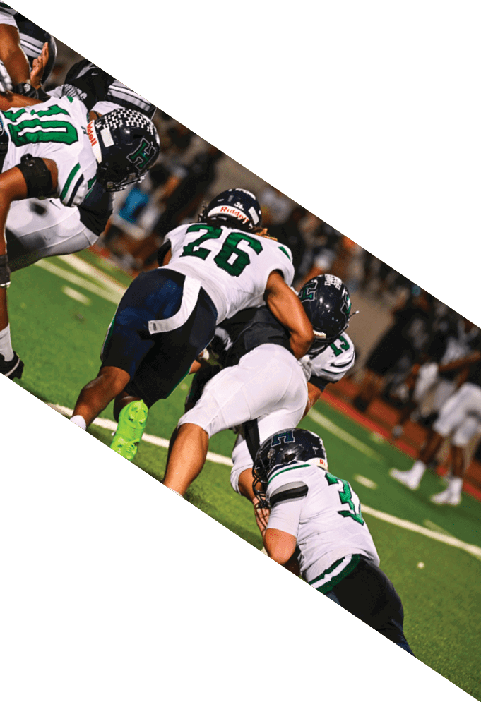Four football players pose for a picture on the field. AI generated content