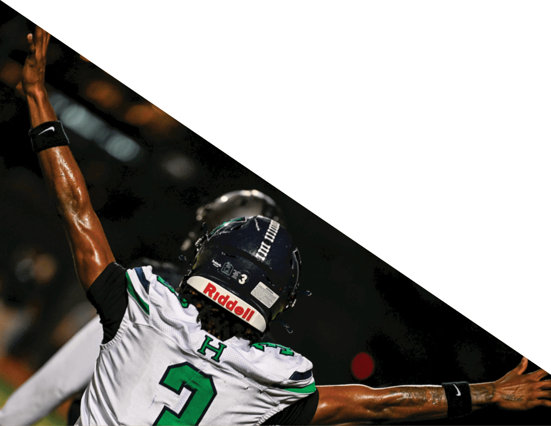 A group of football players kneeling on the field, some with their hands on their heads. AI generated content