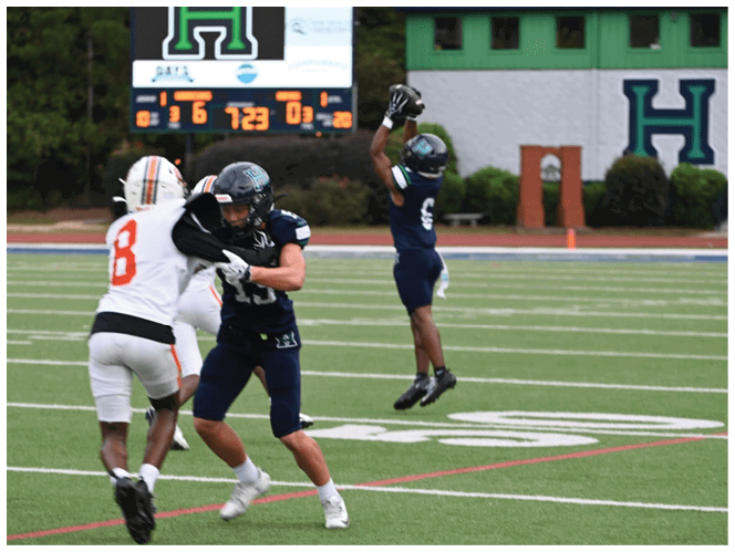 A group of football players in black and white uniforms are on the field. AI generated content