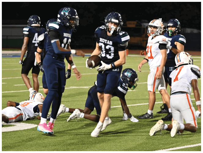A group of football players in black and white uniforms are on the field. AI generated content