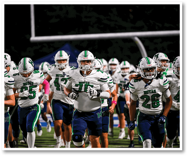 A group of football players wearing black jerseys with the number 3 on them. Description generated by AI
