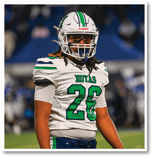 A football player wearing a black jersey with the number 6 on it. Description generated by AI