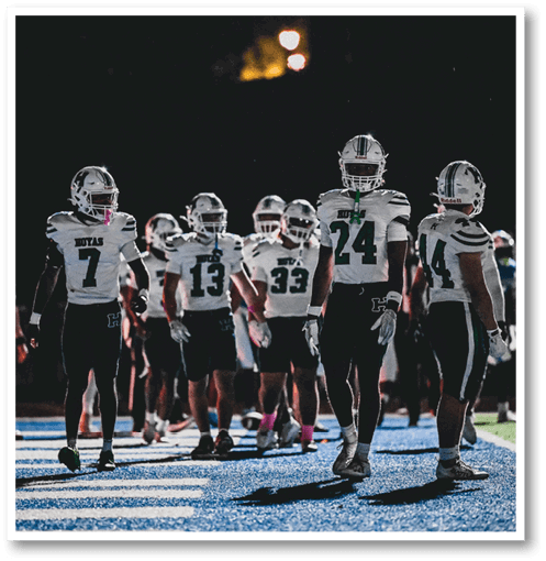 A group of men wearing black and white jerseys. Description generated by AI