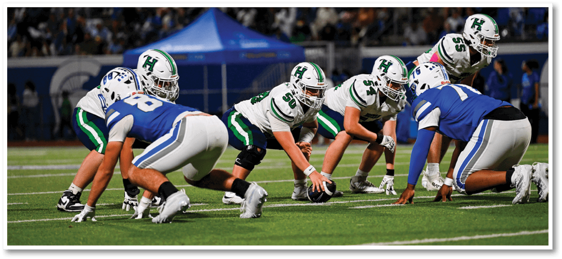 A group of football players on a field. Description generated by AI