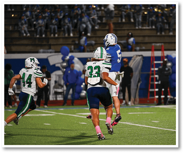 A football player is kicking a football on a field. Description generated by AI