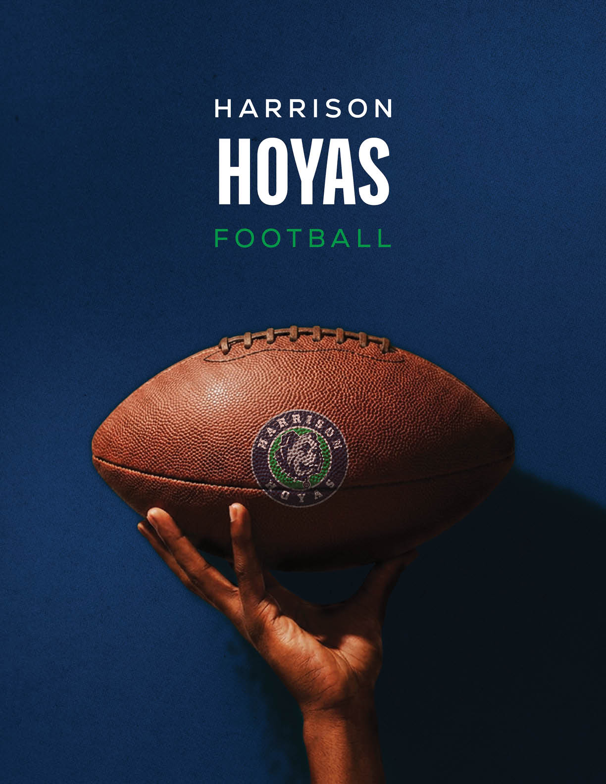 A football is being held by a person. Description generated by AI