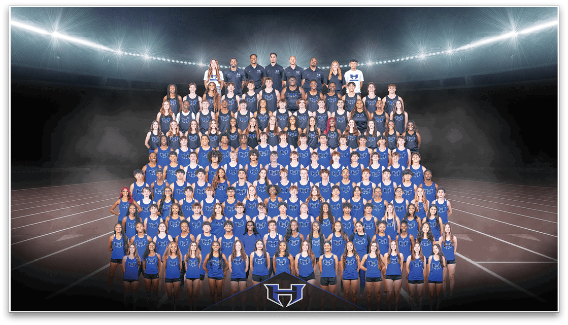 A large group of people wearing matching blue athletic uniforms is arranged in rows on a running track under stadium lights with a logo at the front center. Description generated by AI