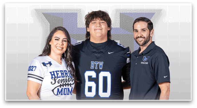 Three people stand smiling with one wearing a sports jersey numbered 60 and the others wearing shirts with “Hebron" logos, suggesting a school sports event. Description generated by AI