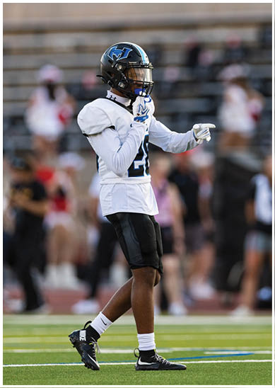 A football player wearing a blue jersey with the number 58 on it. Description generated by AI