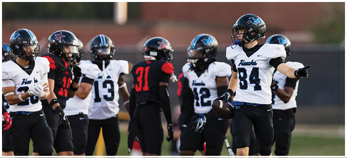 A group of football players on a field. Description generated by AI
