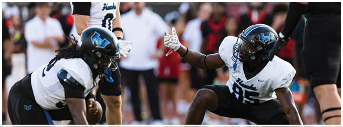 A football player is sliding on the ground. Description generated by AI