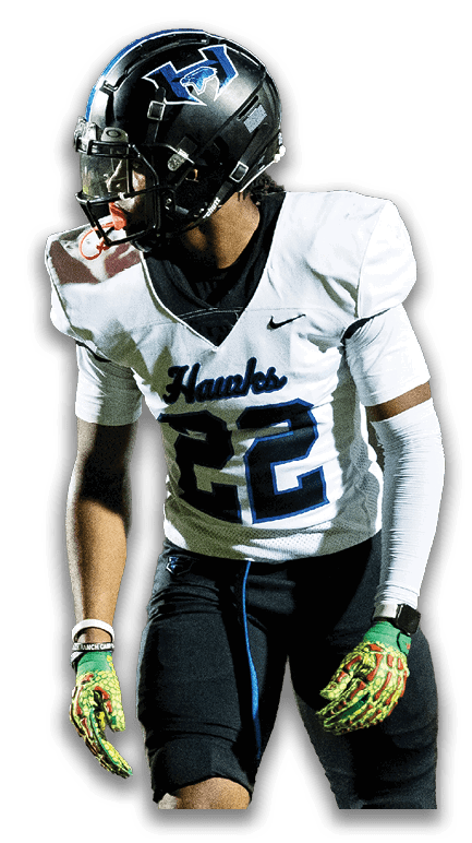 A person wearing a football uniform with a white jersey numbered 22, black pants, a black helmet, and green gloves is standing and looking to the side. Description generated by AI