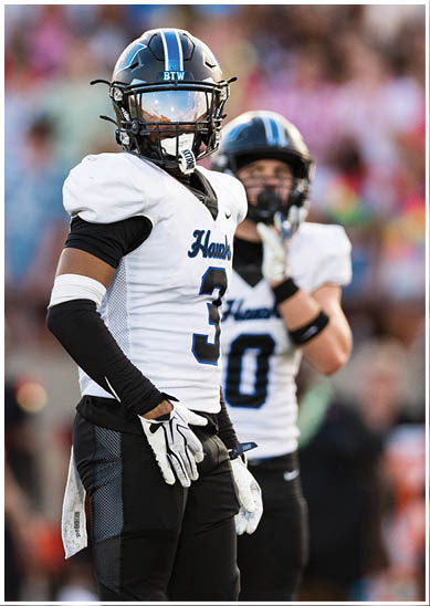 A football player wearing a blue jersey with the number 58 on it. Description generated by AI