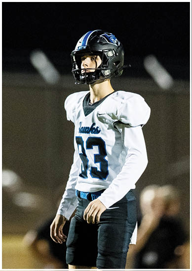 A football player wearing a blue jersey with the number 58 on it. Description generated by AI