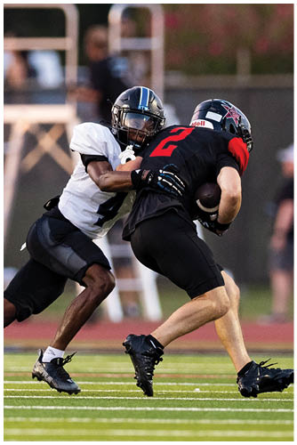 A football player is sliding on the ground. Description generated by AI