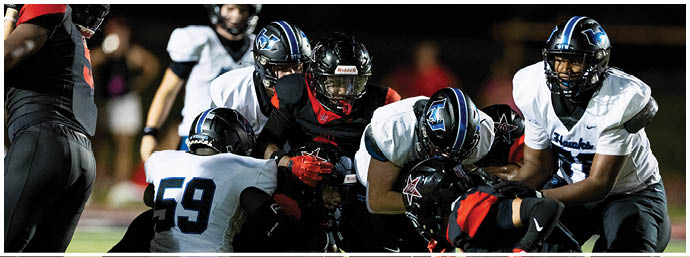 A football player is sliding on the ground. Description generated by AI