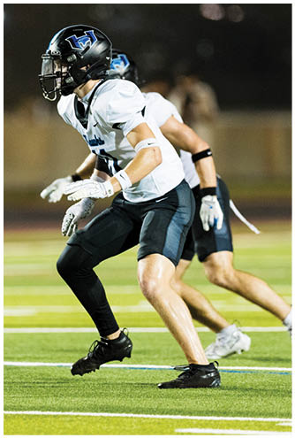 A football player running on the field. Description generated by AI