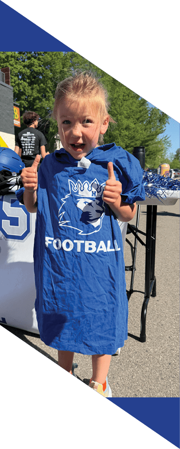 A football player wearing a helmet and white uniform is holding his helmet above his head. AI generated content