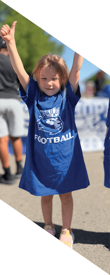 A football player wearing a white jersey with the number 86 catches a football in the air. AI generated content