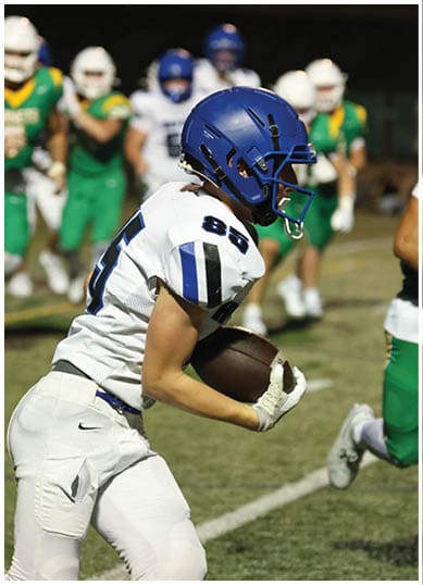 A football player wearing a blue jersey with the number 58 on it. Description generated by AI