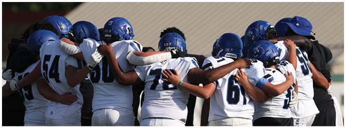 A football player is sliding on the ground. Description generated by AI
