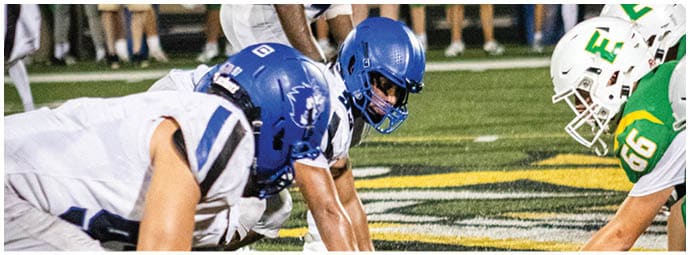 A football player is sliding on the ground. Description generated by AI