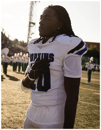 A football player running on the field. Description generated by AI