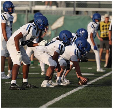 A football player running on the field. Description generated by AI