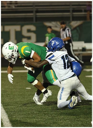 A football player wearing a blue jersey with the number 58 on it. Description generated by AI