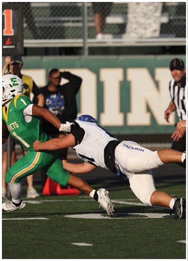 A football player wearing a blue jersey with the number 58 on it. Description generated by AI
