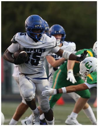 A football player running on the field. Description generated by AI