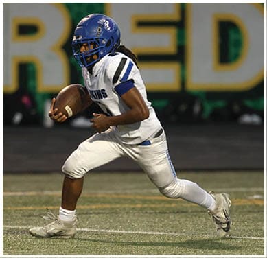 A football player running on the field. Description generated by AI