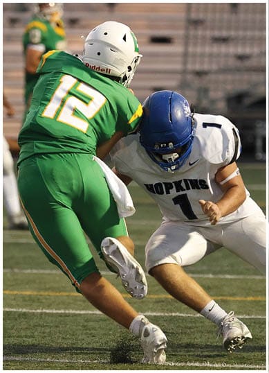 A football player wearing a blue jersey with the number 58 on it. Description generated by AI