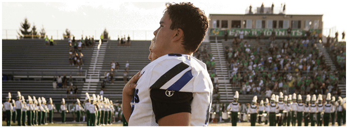 A football player is sliding on the ground. Description generated by AI