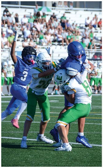 A football player catching a ball. Description generated by AI