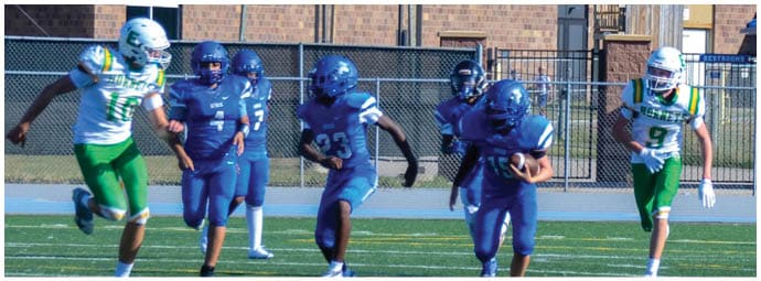 A football player wearing a blue and white uniform. Description generated by AI