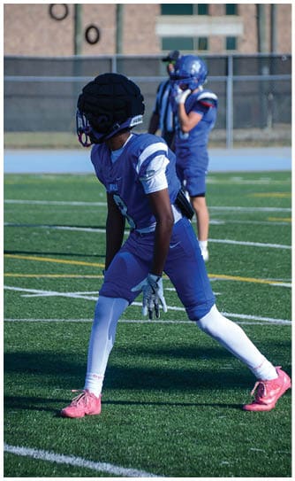 A football player catching a ball. Description generated by AI