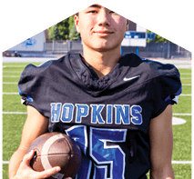 A young man wearing a white jersey with the number 10 on it. Description generated by AI