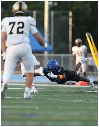 A football player running on the field. Description generated by AI