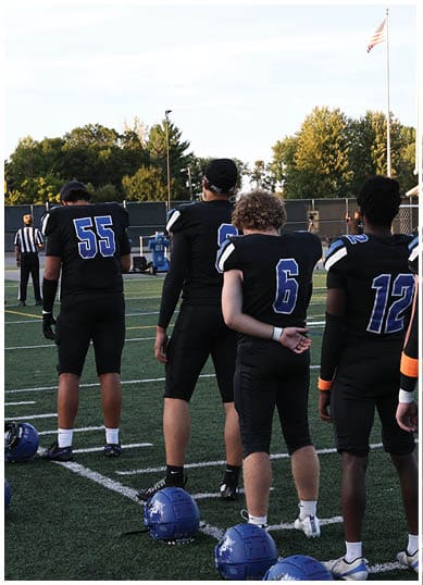 A football player wearing a blue jersey with the number 58 on it. Description generated by AI